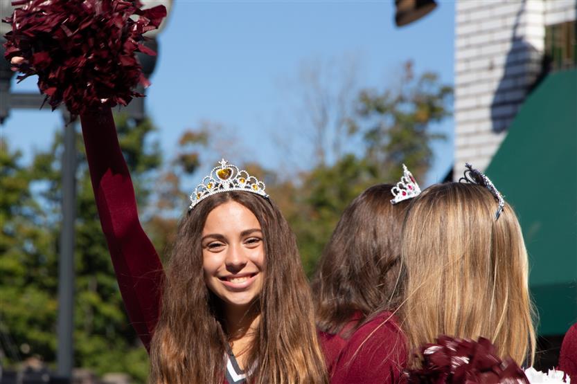 A girl holds up a pom pom